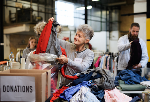 Woman sorting through donated clothing
