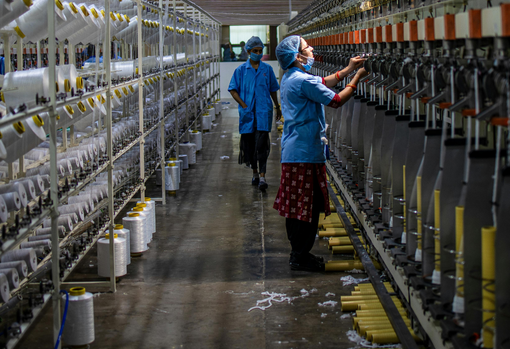 factory-workers Woman sorting through donated clothing