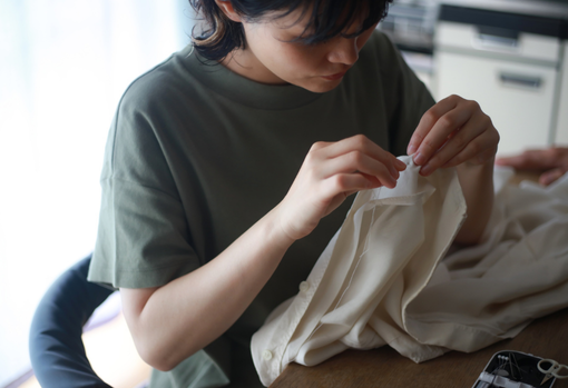 seamstress-repairing-shirt Woman donating a pile of books