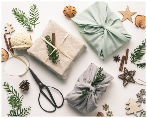 Fabric wrapped present decorated with winter shrubery and berries collected from the garden