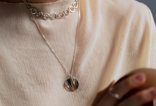 Woman wearing her repaired necklace given as a gift for valentines