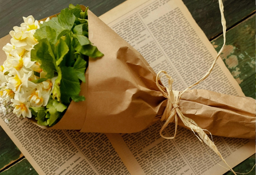 A bunch of seasonal hellebores wrapped in brown paper
