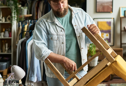man-repairing-chair-at-home Man repairing a chair at home