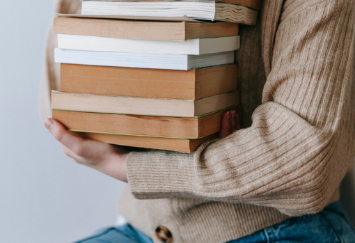 donating-books-03 Woman organising a pile of books for donating