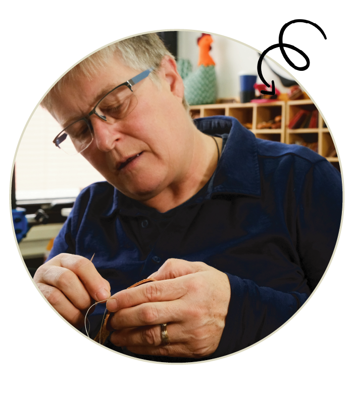 We Are Repairs founders Ally Booker and Gemma Broad leaning against a graffitied wall in central Nottingham.