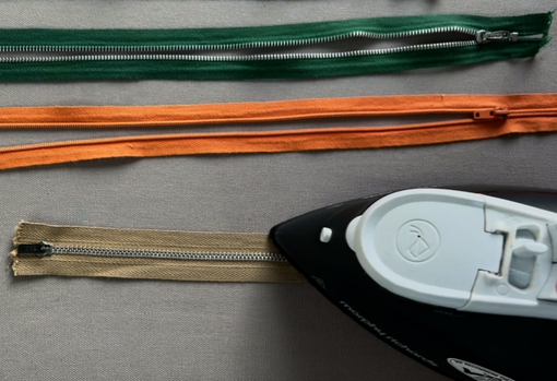 Sewist Sarah from MyVos ironing zips ready for sewing onto the jackets