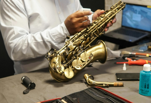 Professional repairer servicing a saxaphone