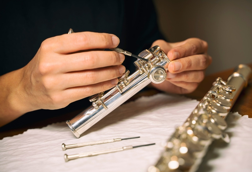 Man taking apart clarinet and cleaning it
