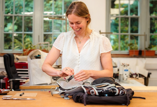 sadie-repairing-backpack-06 Repairer Sadie fixing a backpack