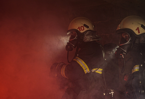 Two Firefighters in smoke-filled room